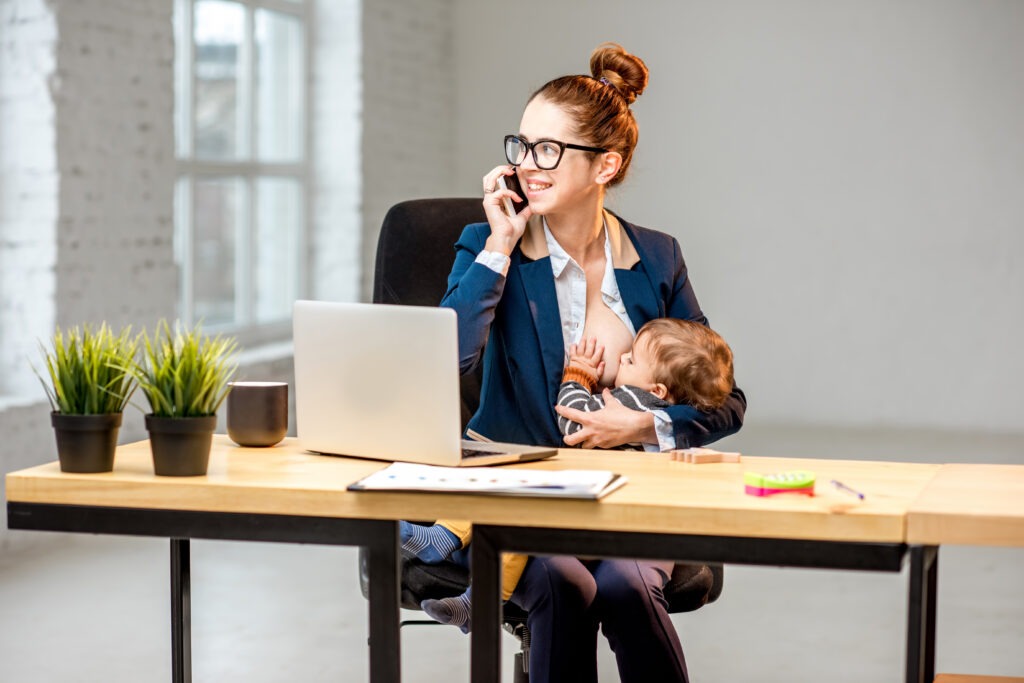 multitasking businesswoman with her son working at the office